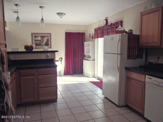 96726 Blackrock Road Yulee, FL 32097 - Photo 6 of 27 a kitchen with a refrigerator and cabinets