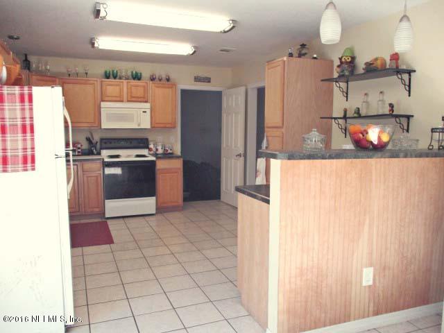 96726 Blackrock Road Yulee, FL 32097 - Photo 10 of 27 a kitchen with stainless steel appliances granite countertop a refrigerator and a sink