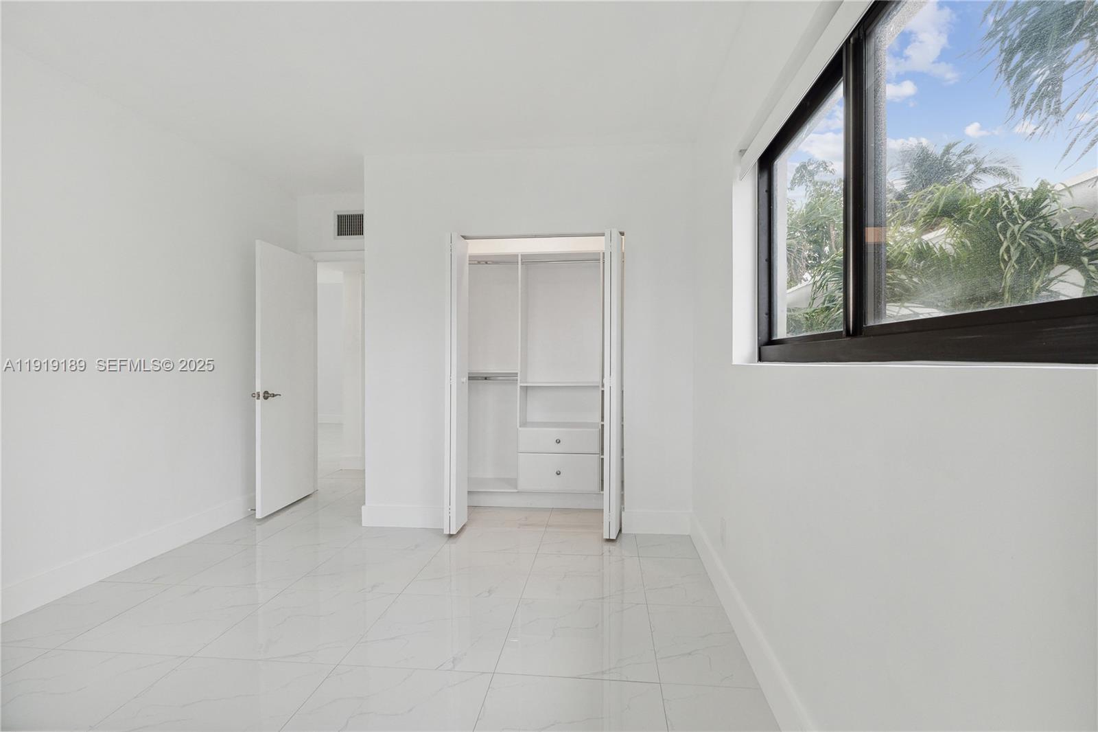 8010 Crespi Boulevard, Unit 4 Miami Beach, FL 33141 - Photo 12 of 16 a view of an empty room with a window