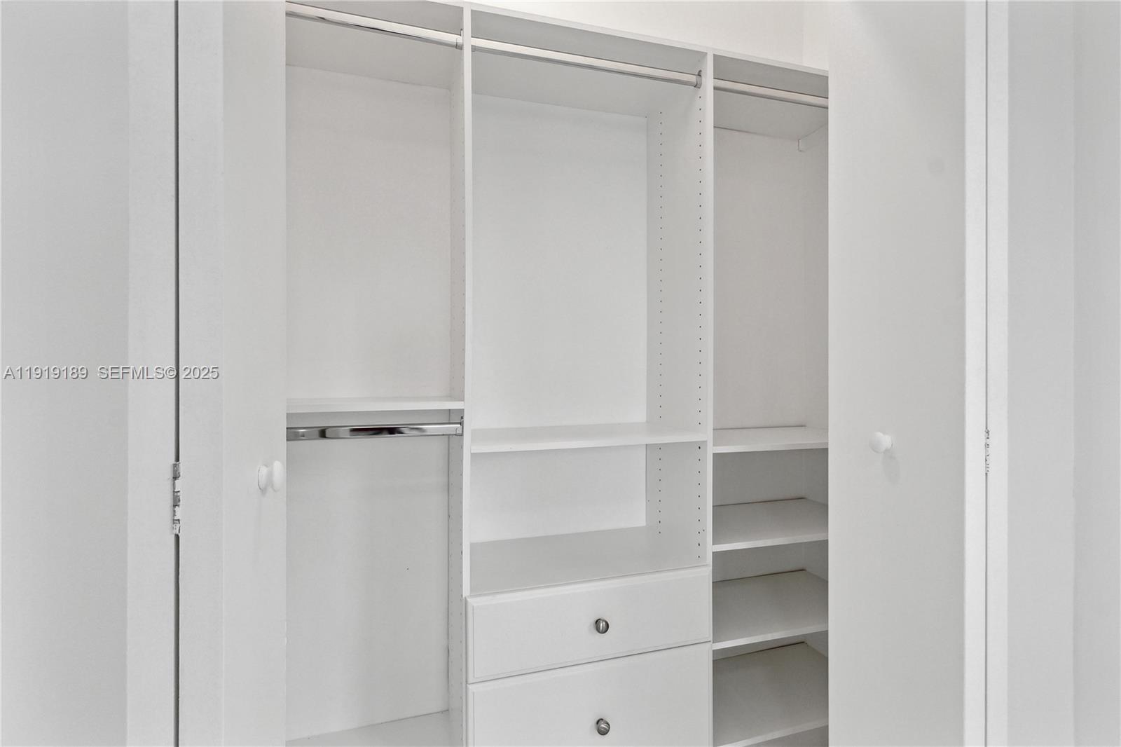 8010 Crespi Boulevard, Unit 4 Miami Beach, FL 33141 - Photo 13 of 16 a view of walk in closet with empty racks