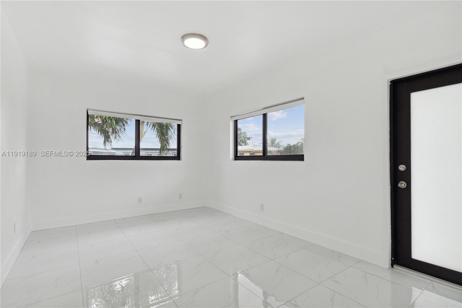 8010 Crespi Boulevard, Unit 4 Miami Beach, FL 33141 - Photo 9 of 16 a view of empty room with windows