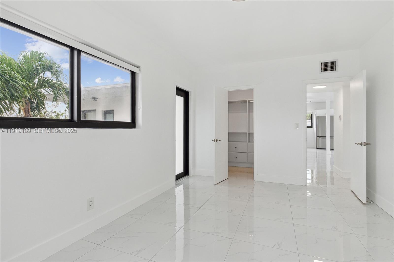 8010 Crespi Boulevard, Unit 4 Miami Beach, FL 33141 - Photo 10 of 16 a view of a hallway with wooden floor and entryway