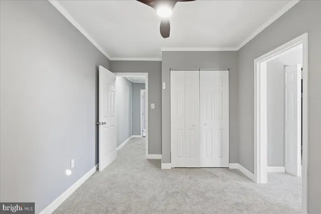 an empty room with windows and closet