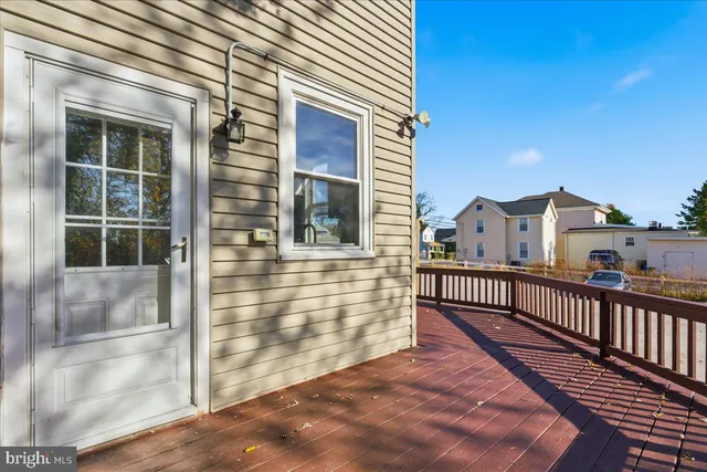 a view of a balcony with wooden floor and fence
