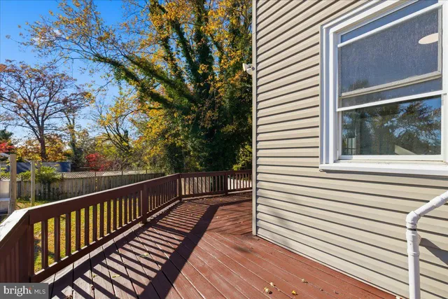 a view of a house with a wooden fence