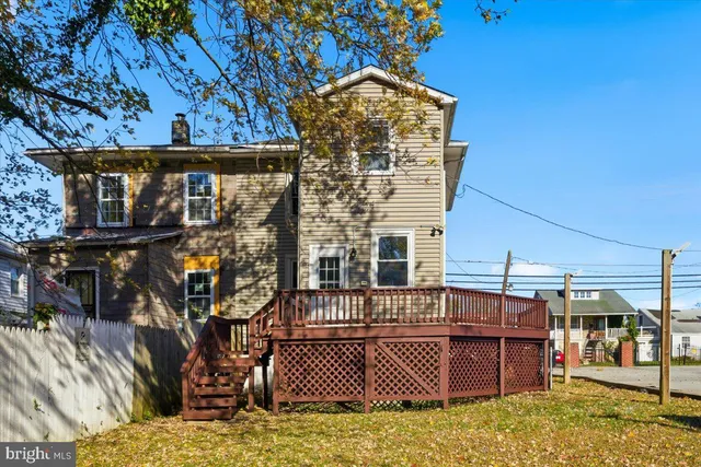 a view of a brick house with a small yard