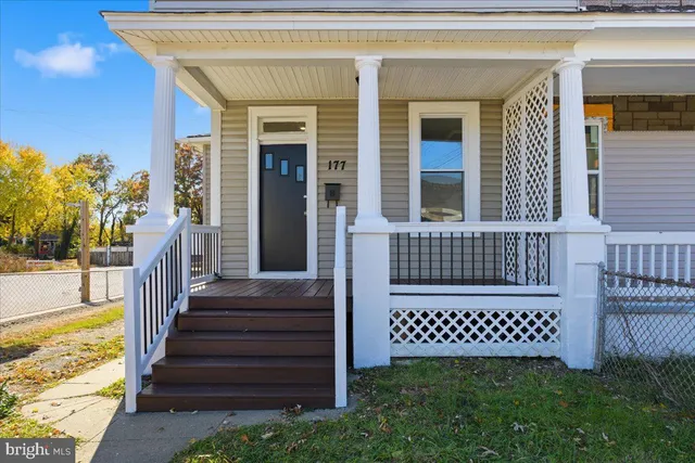 a view of a brick house with a yard