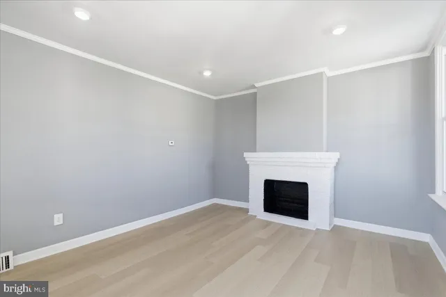 a view of empty room with a fireplace