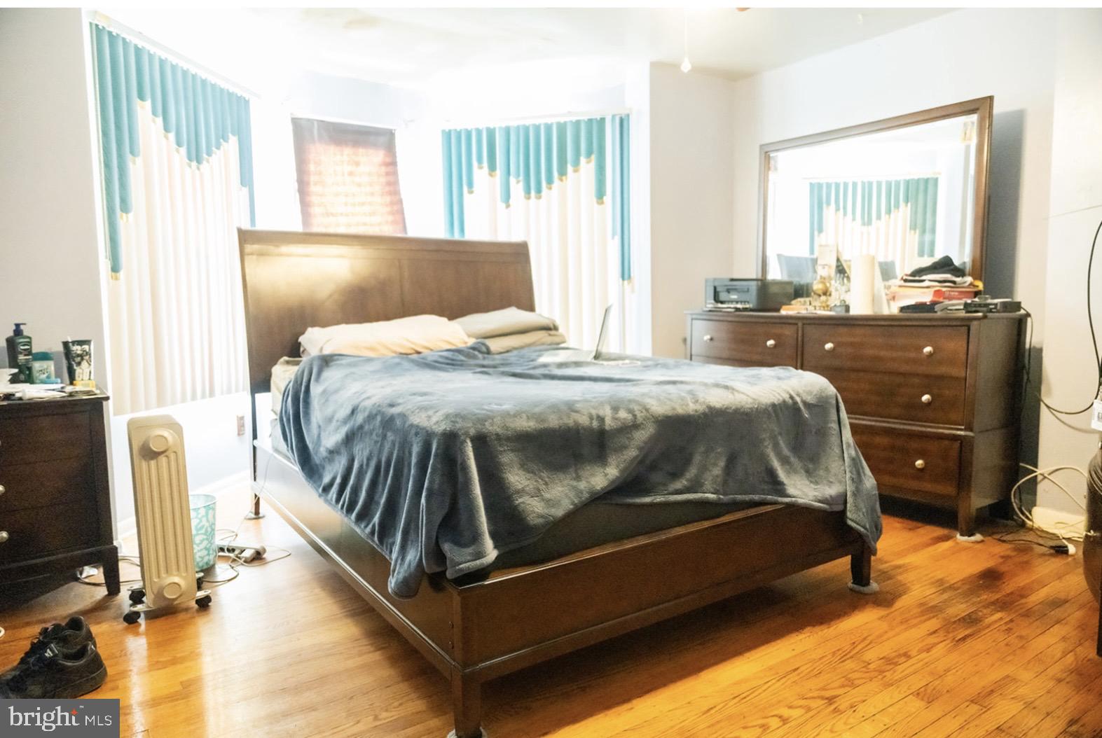 6021 Chestnut Street Philadelphia, PA 19139 - Photo 11 of 21 a bedroom with a bed and wooden floor