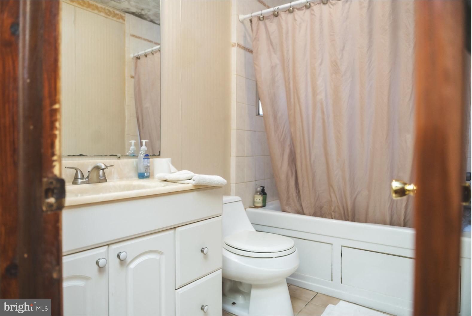 6021 Chestnut Street Philadelphia, PA 19139 - Photo 14 of 21 a bathroom with a sink a toilet and shower