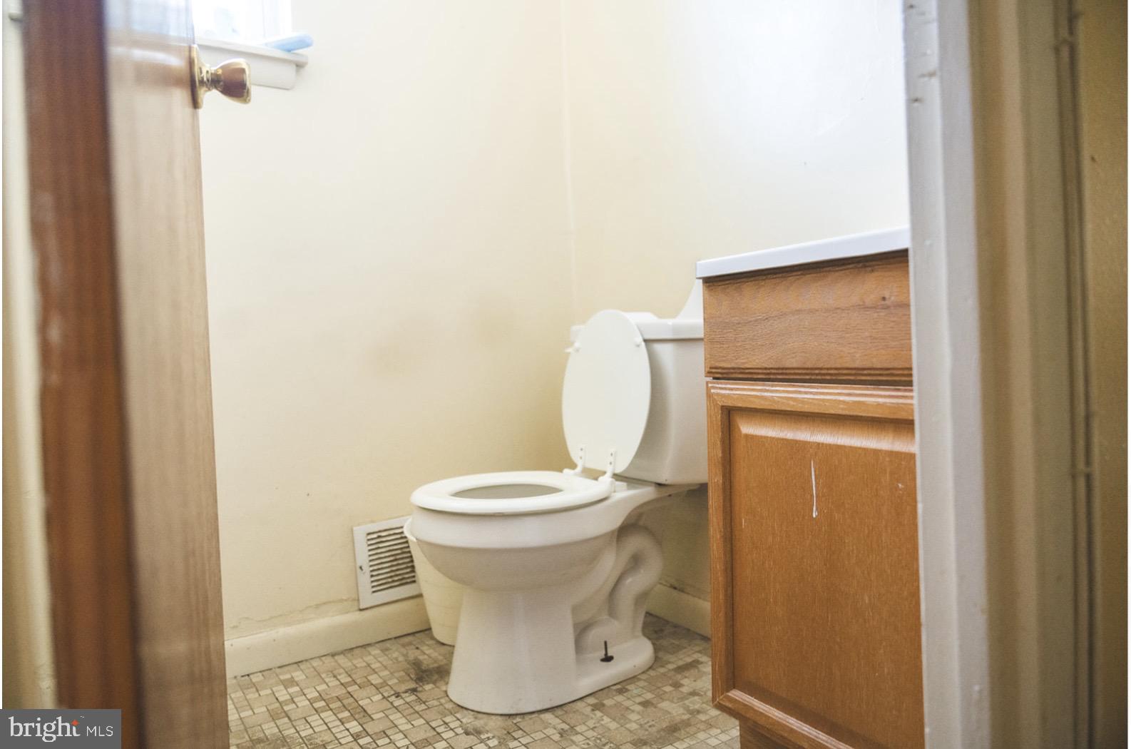 6021 Chestnut Street Philadelphia, PA 19139 - Photo 16 of 21 a white toilet sitting next to a shower