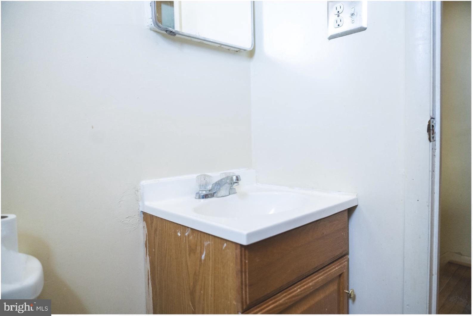 6021 Chestnut Street Philadelphia, PA 19139 - Photo 17 of 21 a bathroom with a sink and a toilet