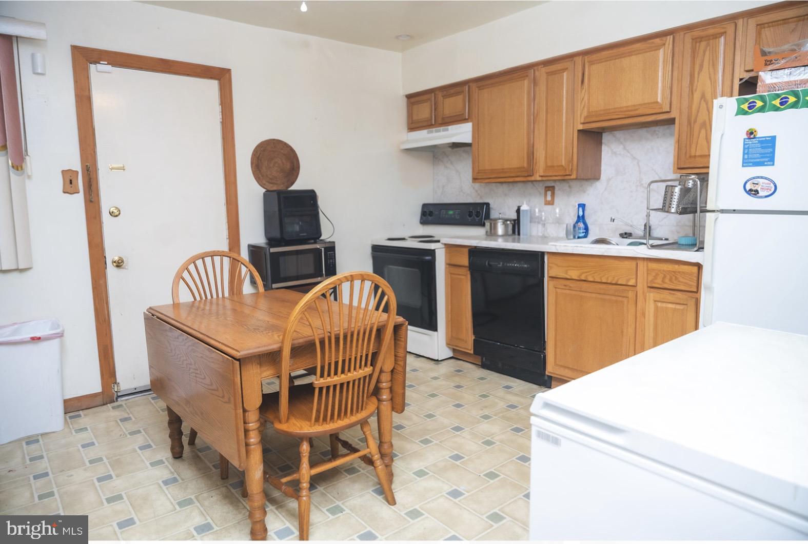 6021 Chestnut Street Philadelphia, PA 19139 - Photo 5 of 21 a kitchen with a sink appliances and cabinets