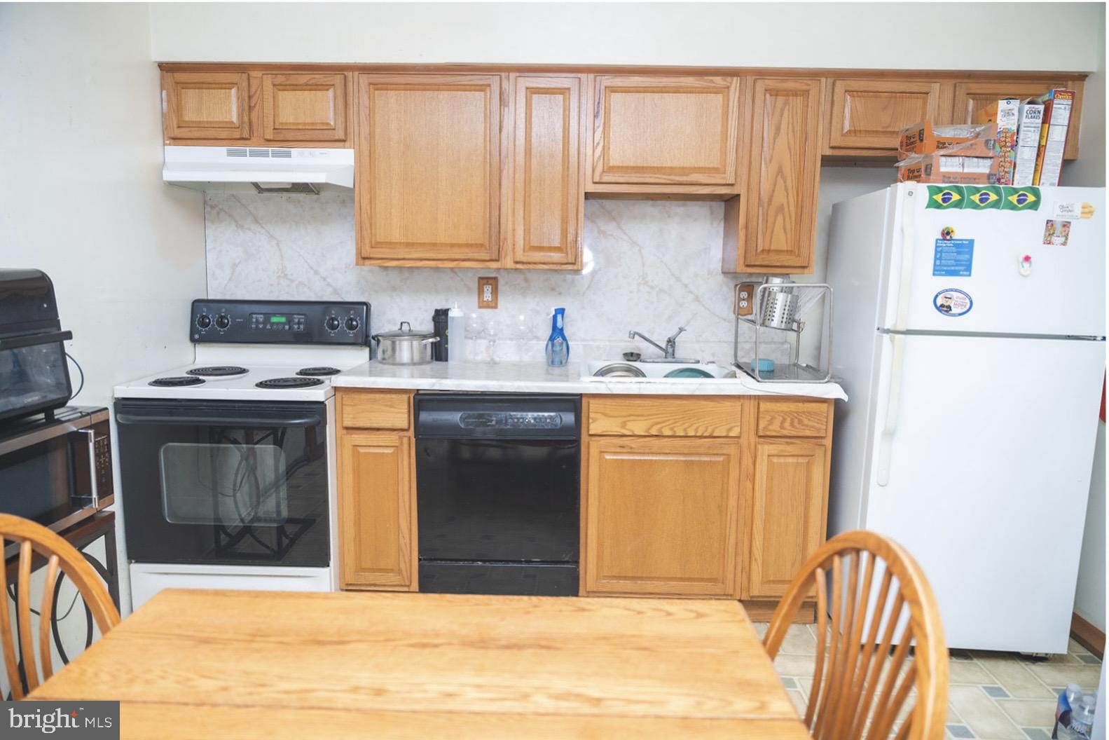 6021 Chestnut Street Philadelphia, PA 19139 - Photo 6 of 21 a kitchen with stainless steel appliances granite countertop a stove a sink and a microwave