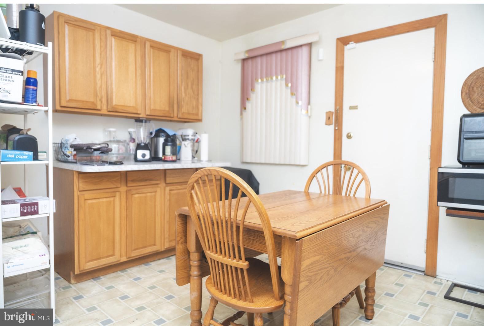6021 Chestnut Street Philadelphia, PA 19139 - Photo 7 of 21 a view of a kitchen area with furniture and wooden floor