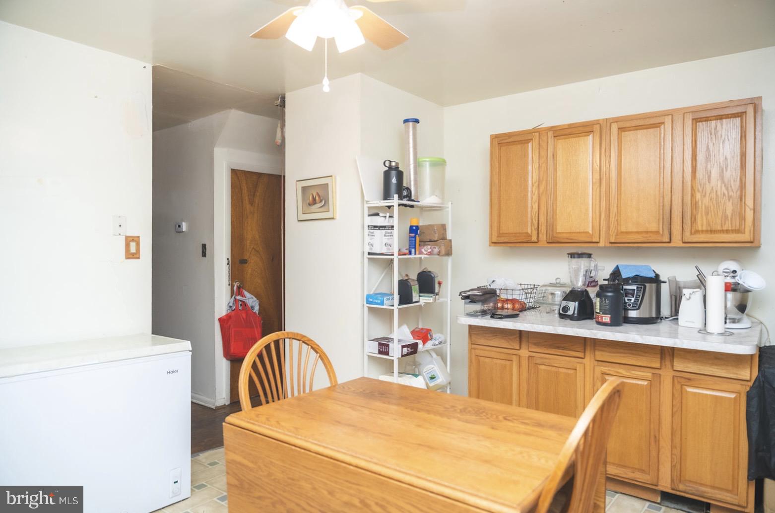 6021 Chestnut Street Philadelphia, PA 19139 - Photo 8 of 21 a kitchen with stainless steel appliances granite countertop a stove top oven a sink dishwasher and white cabinets with wooden floor