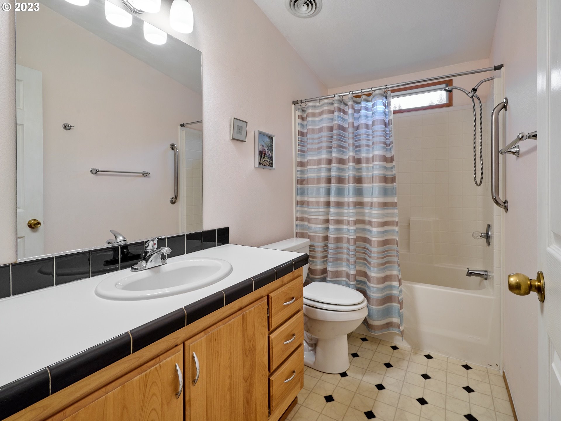 4430 Palmer Road Dallas, OR 97338 - Photo 18 of 22 a bathroom with a sink a toilet a shower and a mirror