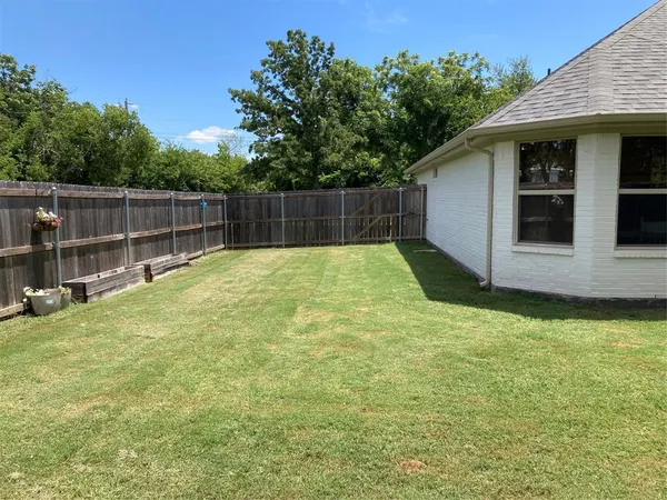a swimming pool with some trees in the background