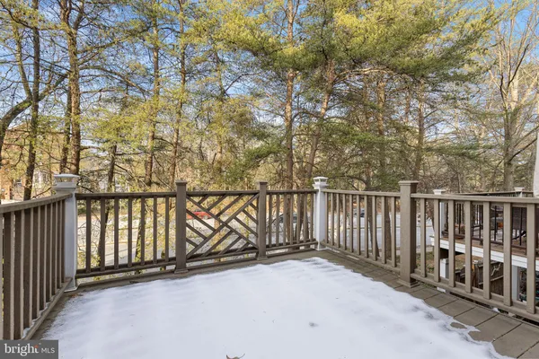 a kitchen with kitchen island a stove a sink and a refrigerator with wooden floor