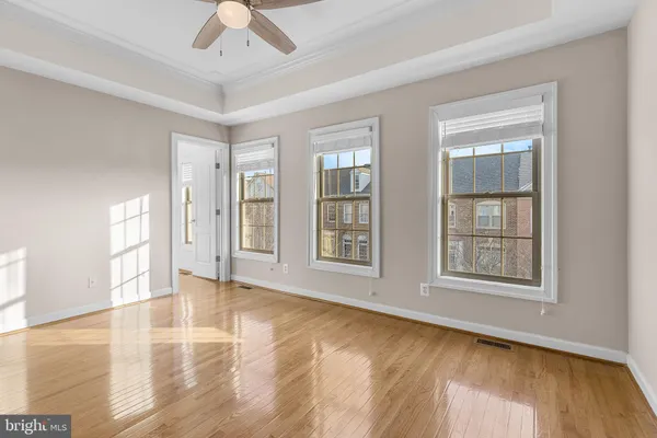 a view of a room with wooden floor and windows
