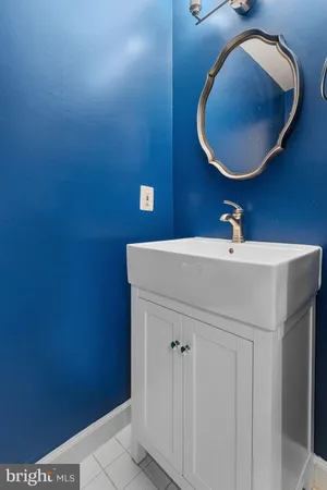 an empty room with ceiling fan and windows