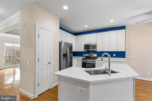 a kitchen with stainless steel appliances a refrigerator sink and microwave
