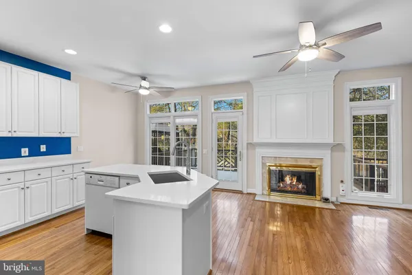 a open kitchen with sink cabinets and wooden floor