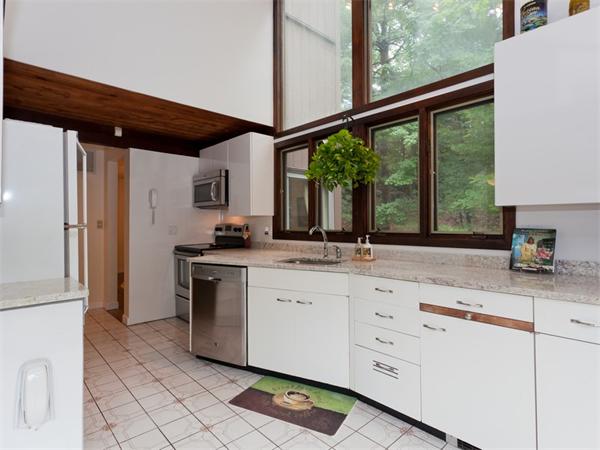 446 South Border Road Winchester, MA 01890 - Photo 8 of 18 a kitchen with granite countertop white cabinets and white appliances