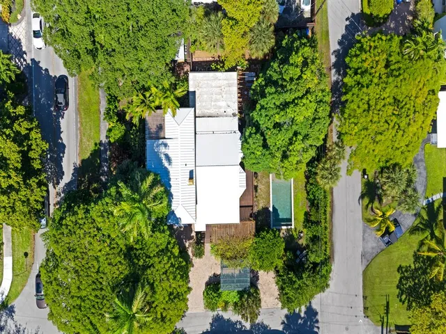 an aerial view of a house with a yard and garden