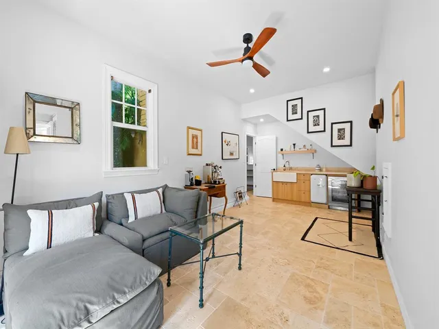 a living room with furniture and kitchen view