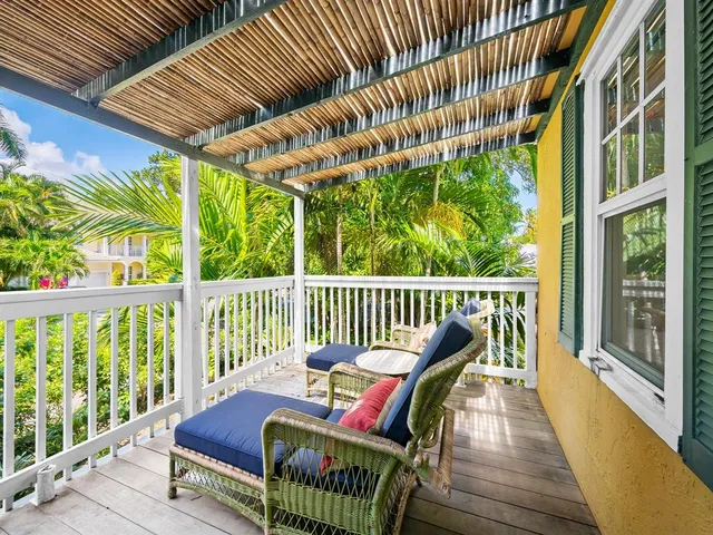 a view of a two chairs in the balcony