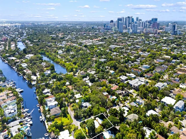 an aerial view of residential houses with city view
