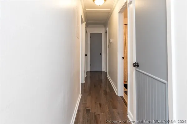 a view of a hallway with wooden floor