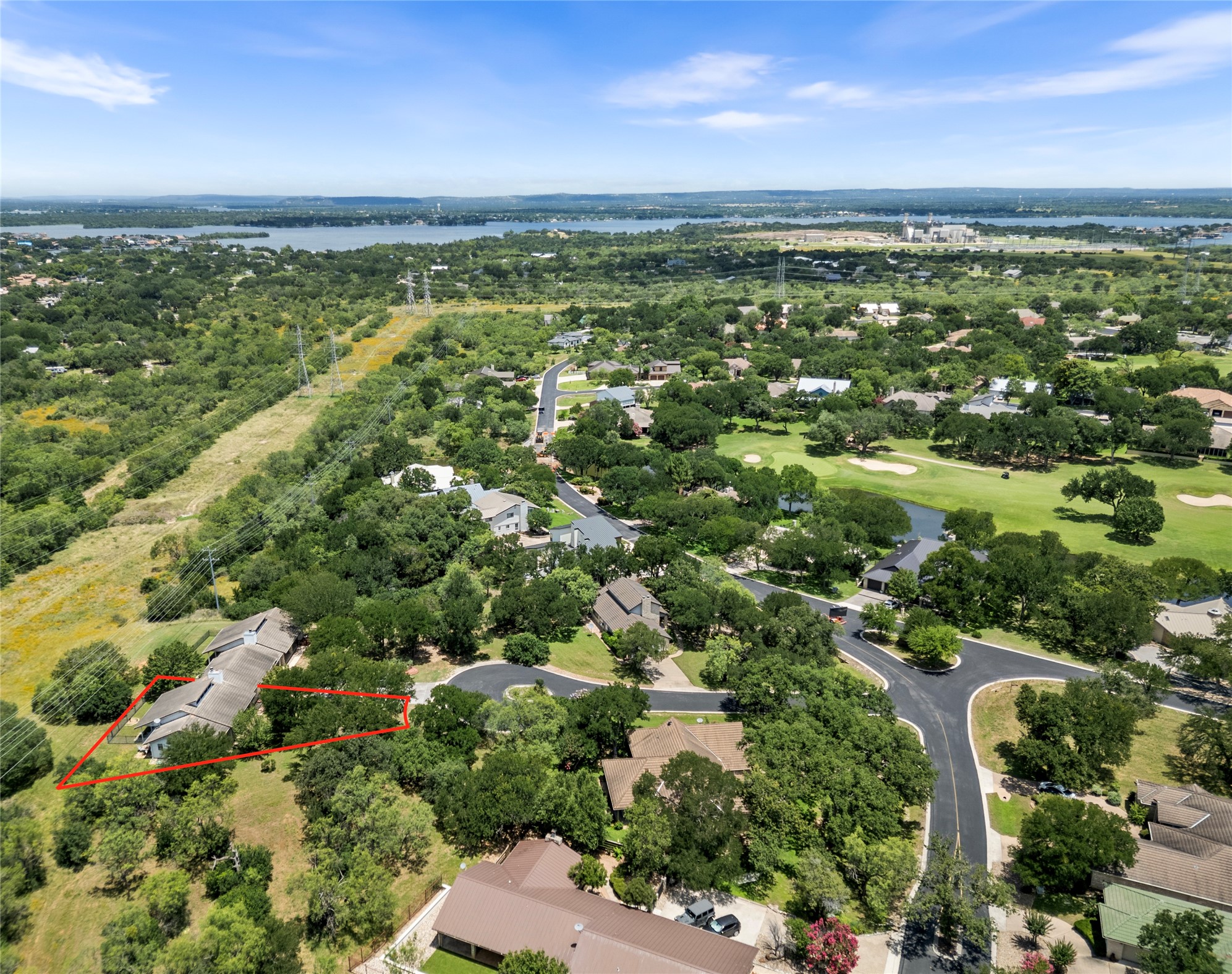 210 Teeoff, Unit B Horseshoe Bay, TX 78657 - Photo 36 of 38 An aerial perspective reveals a verdant golf course community nestled near a serene body of water.