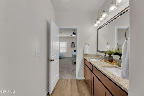a living room with furniture kitchen view and a chandelier