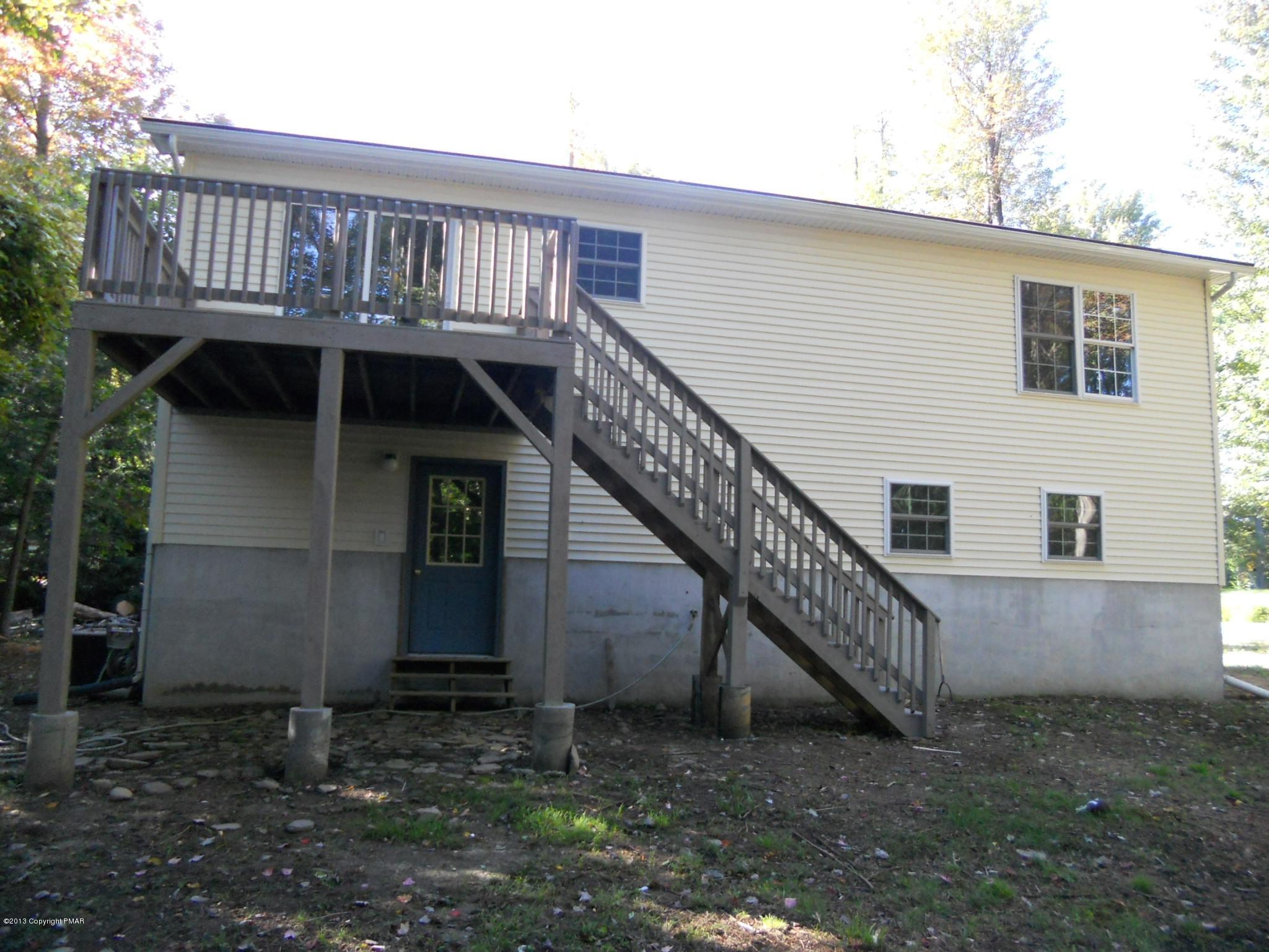 1123 Rhododendron Lane Pocono Summit, PA 18346 - Photo 2 of 10 a view of backyard with wooden deck and seating space