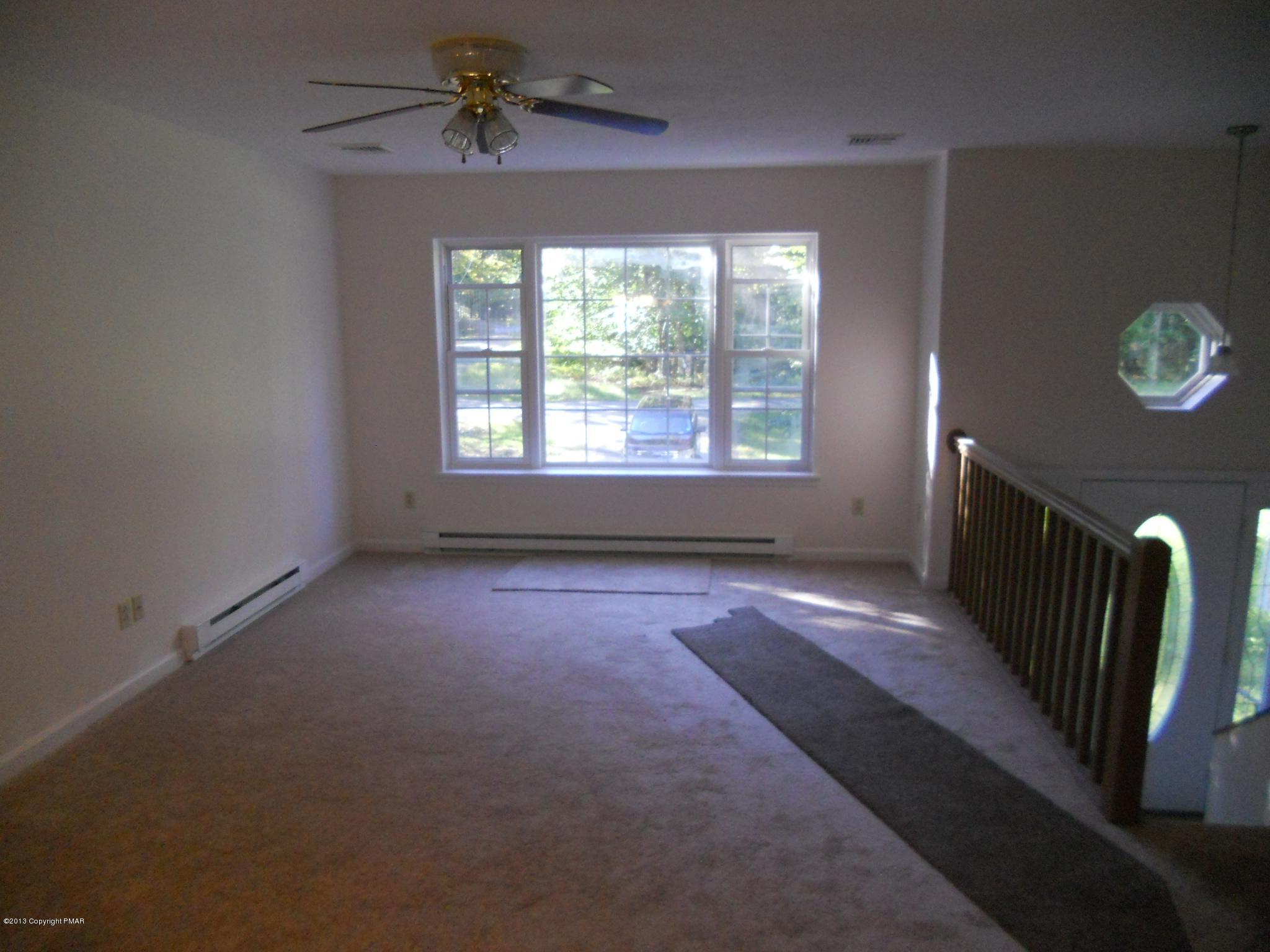 1123 Rhododendron Lane Pocono Summit, PA 18346 - Photo 3 of 10 wooden floor in an empty room with a window