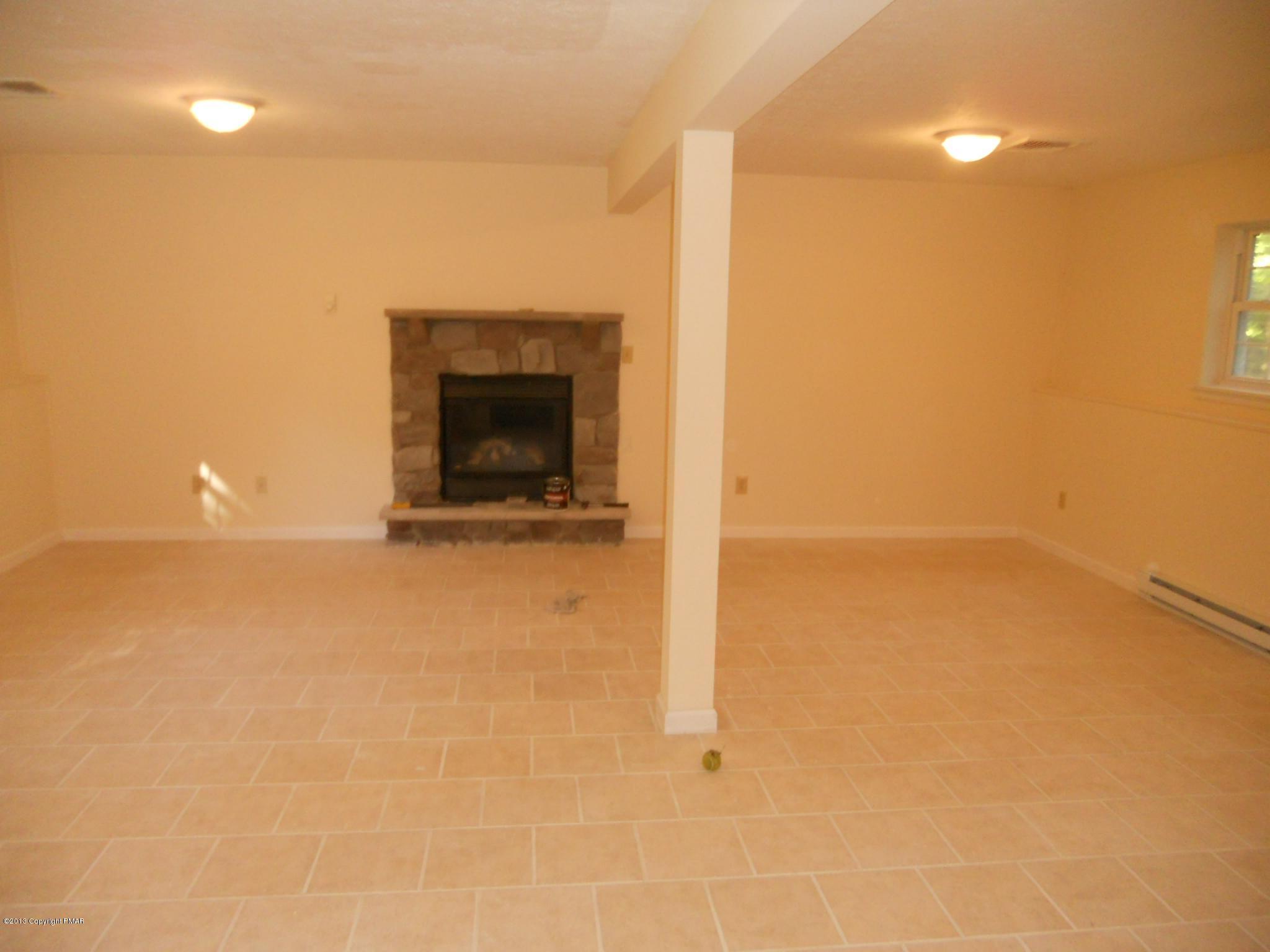 1123 Rhododendron Lane Pocono Summit, PA 18346 - Photo 9 of 10 a view of an empty room with a fireplace