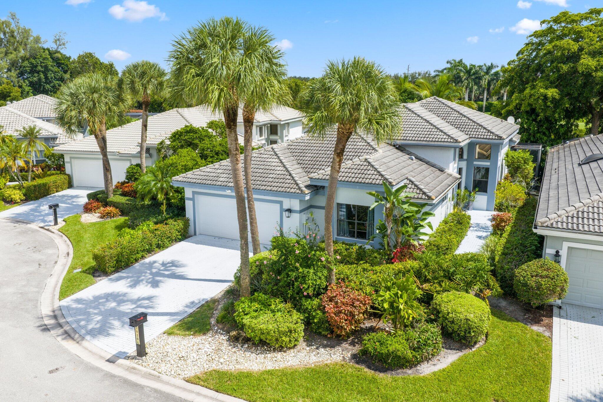 a aerial view of a house with a yard and potted plants