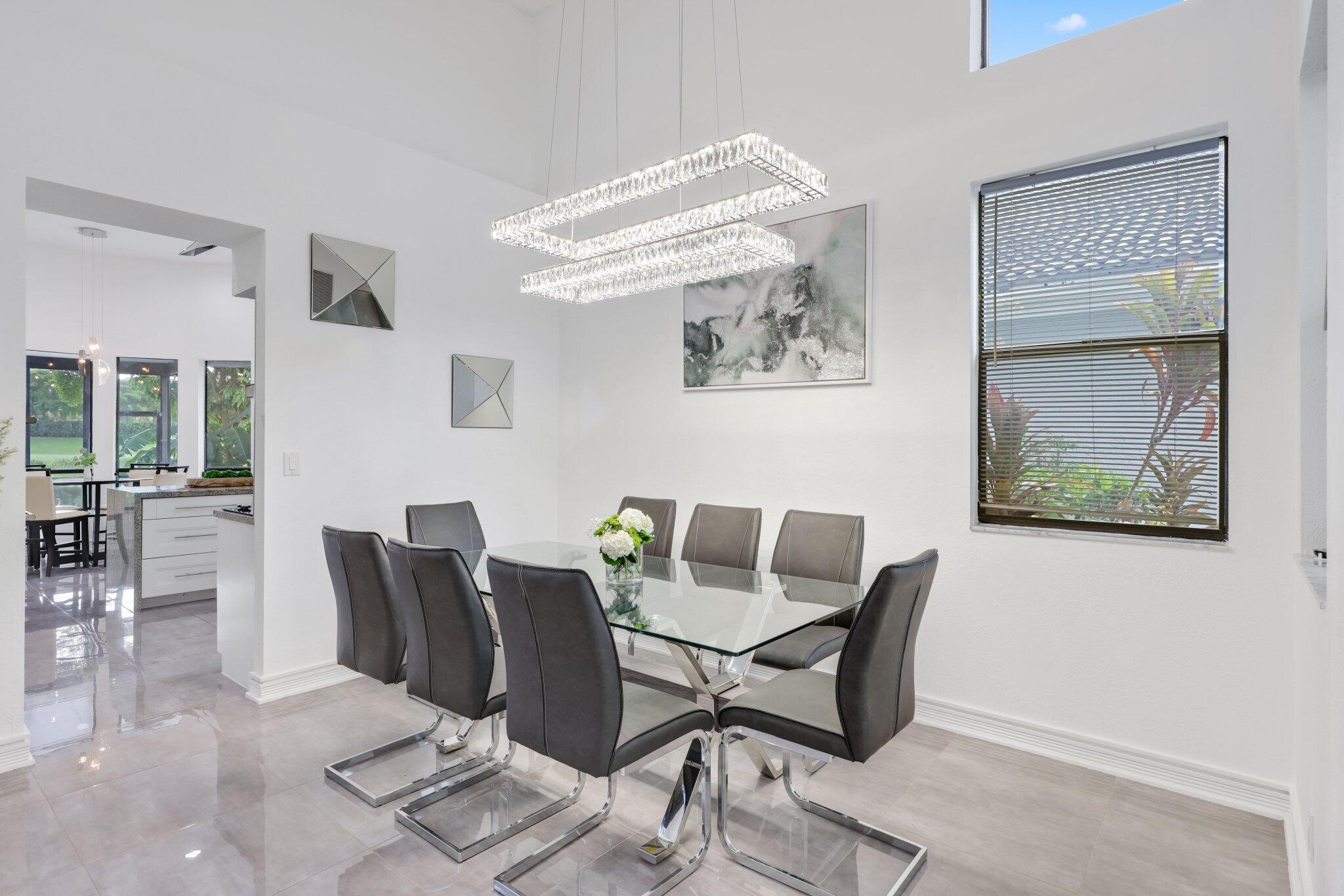 10106 Spyglass Way Boca Raton, FL 33498 - Photo 13 of 44 a view of a dining room with furniture and wooden floor