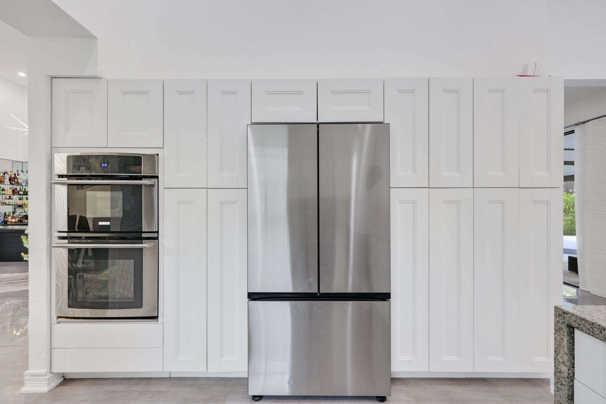 10106 Spyglass Way Boca Raton, FL 33498 - Photo 17 of 44 a metallic refrigerator freezer sitting in a kitchen
