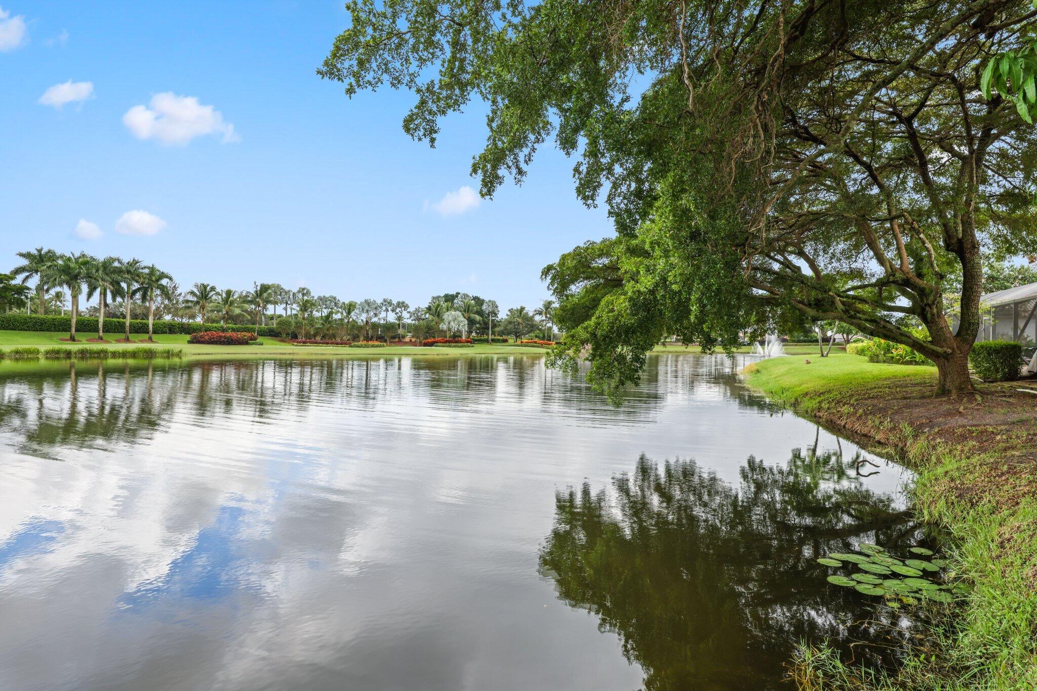 10106 Spyglass Way Boca Raton, FL 33498 - Photo 2 of 44 a view of a lake with houses in the back