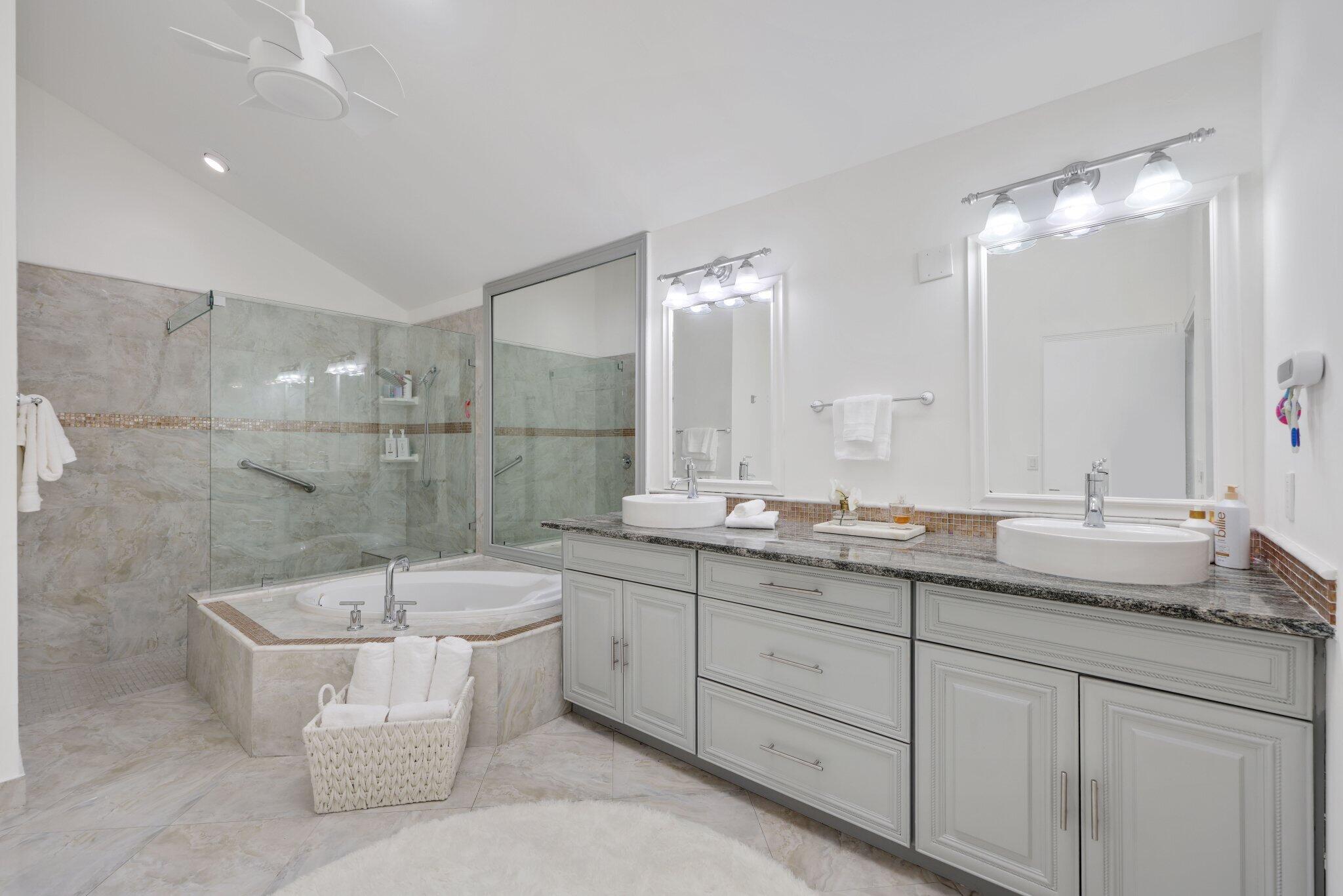 10106 Spyglass Way Boca Raton, FL 33498 - Photo 21 of 44 a bathroom with a double vanity sink mirror and bathtub
