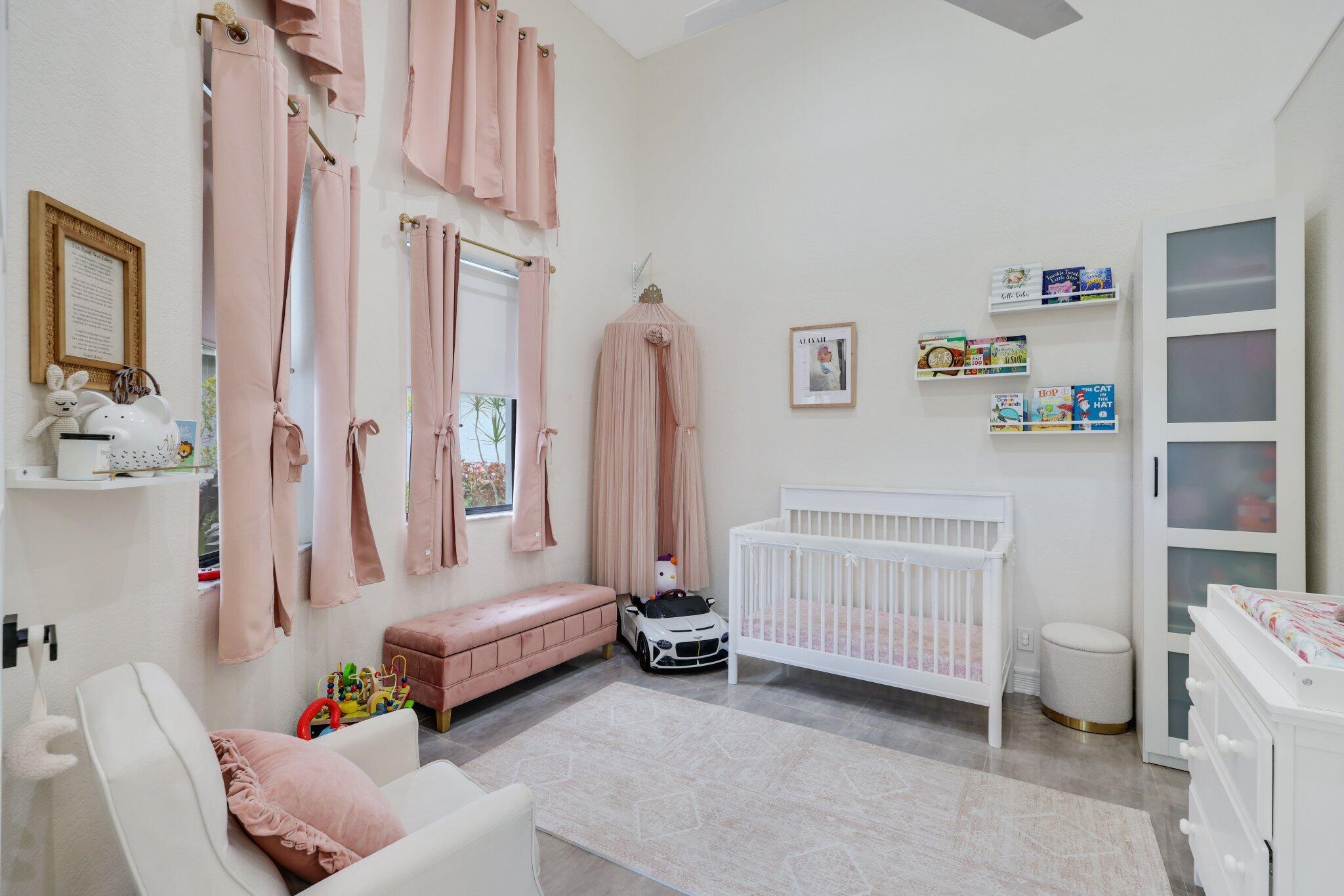 10106 Spyglass Way Boca Raton, FL 33498 - Photo 22 of 44 a bedroom with baby crib and a couch