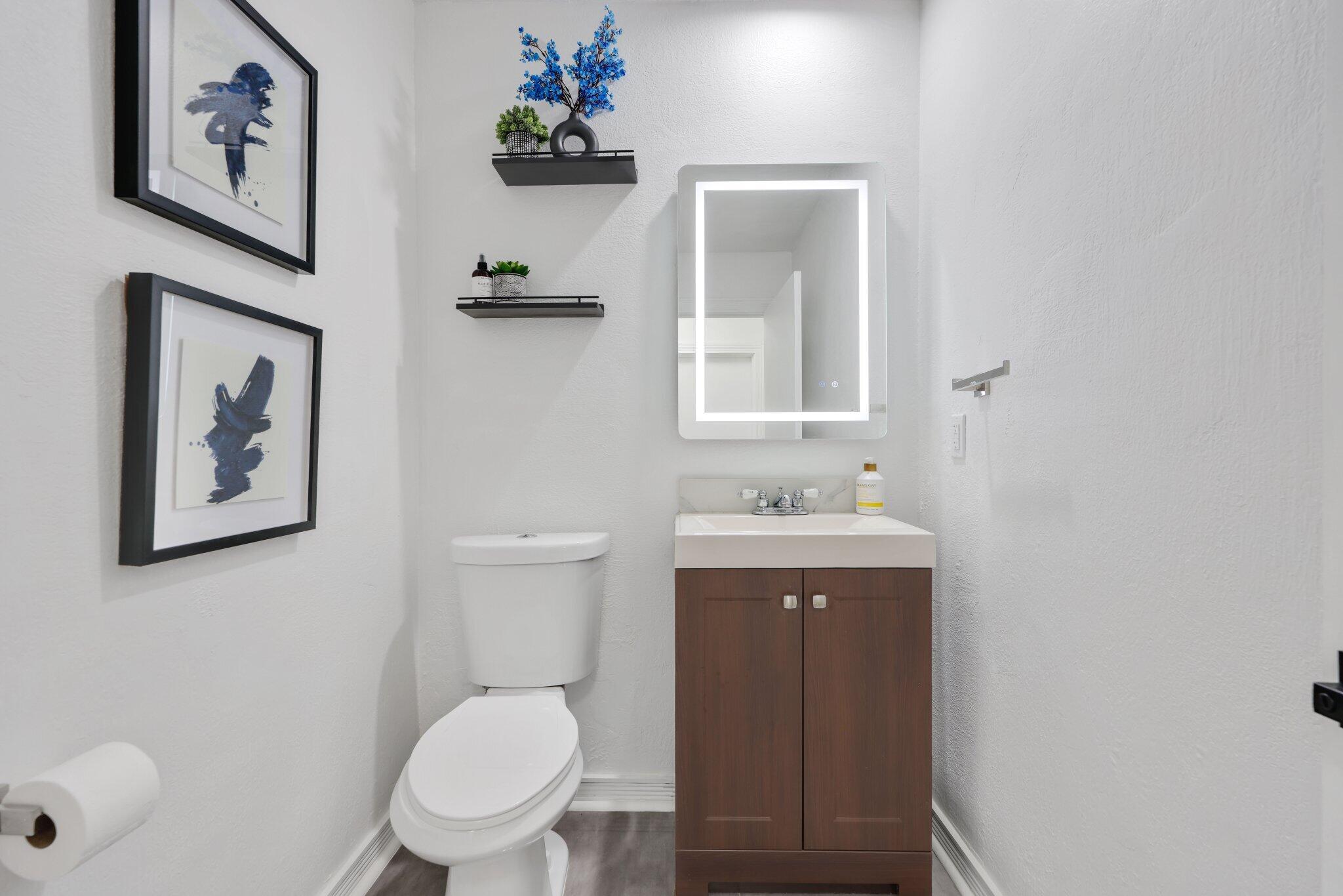 10106 Spyglass Way Boca Raton, FL 33498 - Photo 25 of 44 a bathroom with a toilet sink and mirror