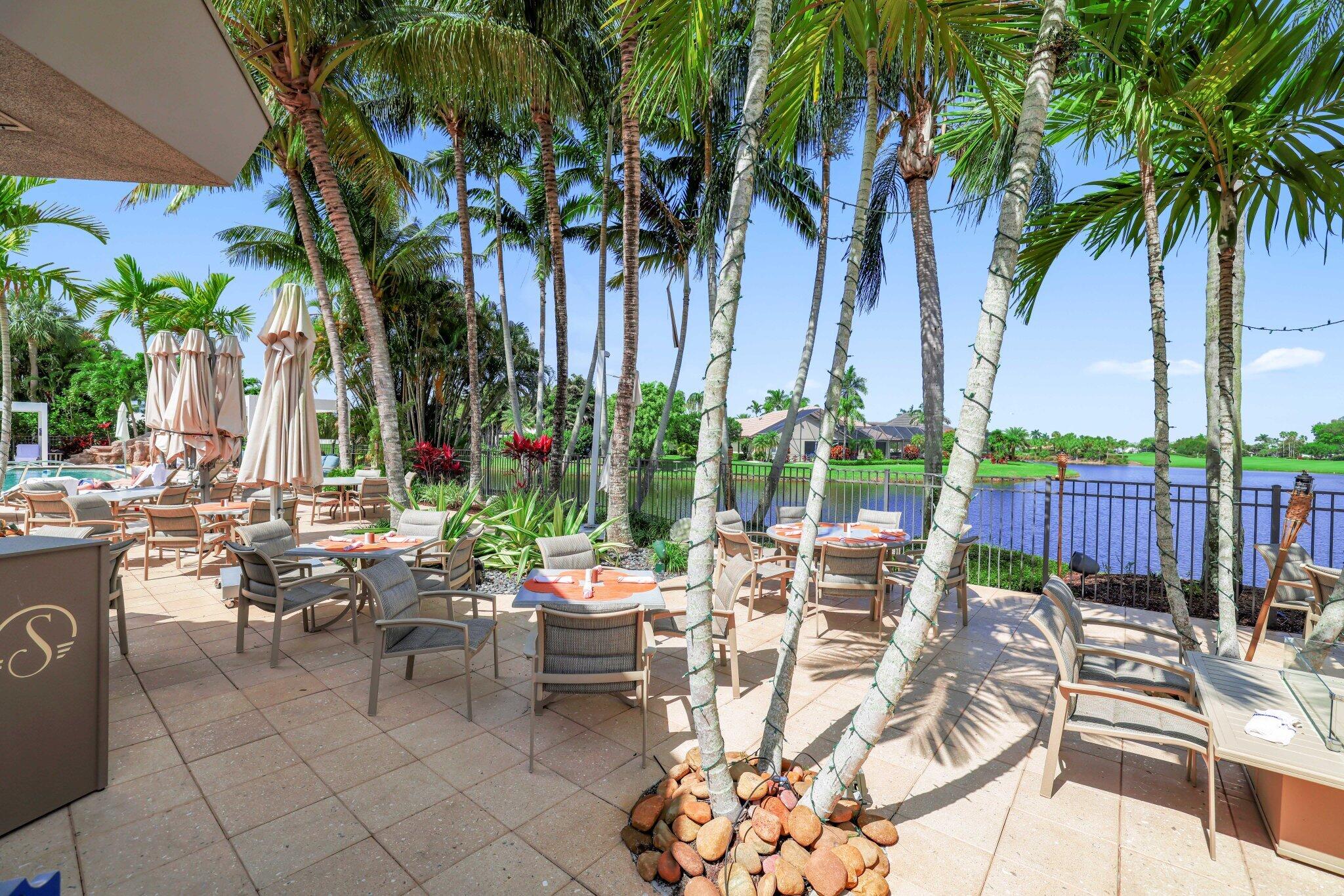 10106 Spyglass Way Boca Raton, FL 33498 - Photo 38 of 44 a view of a patio with furniture and a fire pit