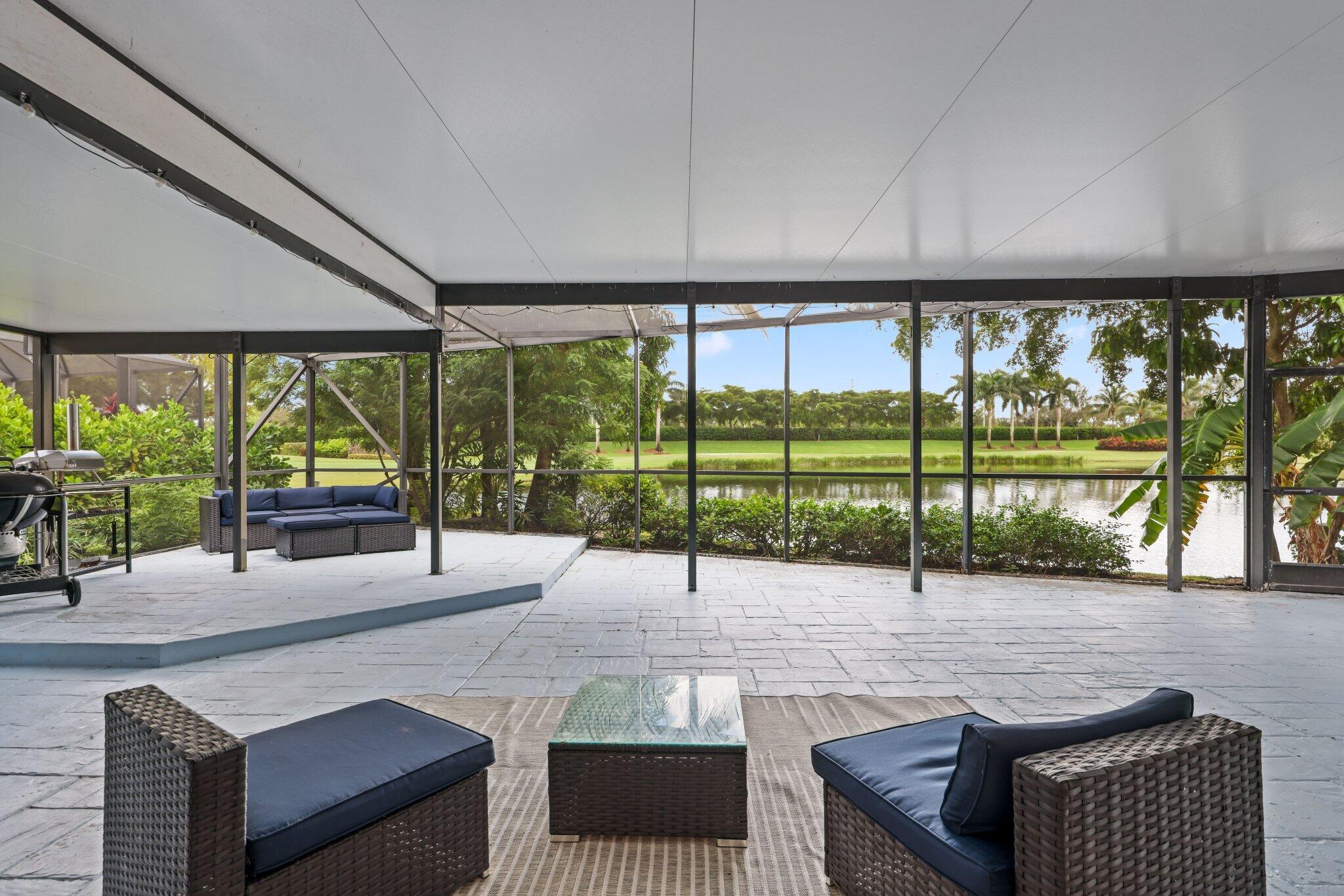 10106 Spyglass Way Boca Raton, FL 33498 - Photo 8 of 44 a living room with large windows