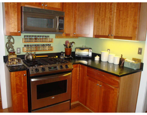 81 Robbins Road Watertown, MA 02472 - Photo 2 of 11 a kitchen with stainless steel appliances a stove a microwave a sink and cabinets