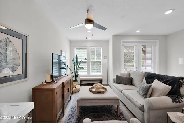 a living room with furniture and a large window