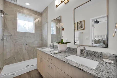 a bathroom with a double vanity sink and a mirror